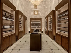 A modern retail store interior featuring wooden shelves and marble flooring.