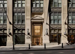 Modern retail storefront featuring glass, stone, and metal architectural elements
