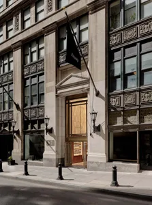 A modern storefront featuring glass, brick, and concrete materials.