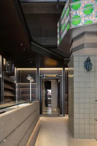 Modern commercial space featuring industrial design elements and concrete shapes.