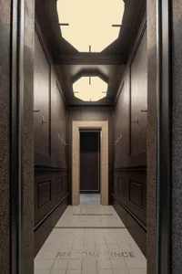 Marble hotel corridor with skylights and a limestone door frame.