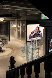 A modern retail space featuring glass partitions and shelves.
