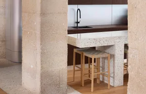 Modern kitchen with terrazzo countertop and minimalist design.
