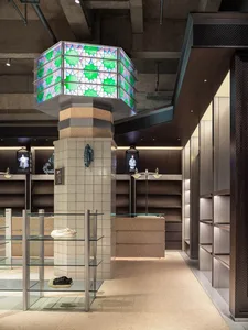 Modern retail store interior with concrete and tiled walls, showcasing sleek and contemporary design.