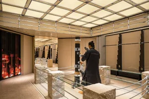 A modern retail store featuring glass, concrete, and metal elements.