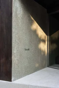 Concrete exterior wall with sunlight casting shadows