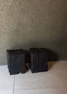 Industrial-style wooden blocks against a textured wall.