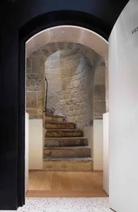 A rustic stone staircase within a building.