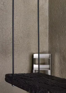 A modern floating desk with a concrete top and metal legs.