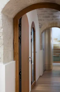 Modern hallway with wooden doors and glass panel