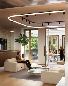 A modern living room featuring sofas and glass doors.