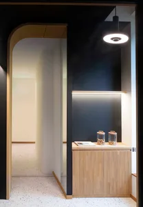 A minimalist entryway with solid wood elements and soft ambient lighting.