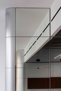 Modern office elevator interior featuring metallic glass and concrete elements