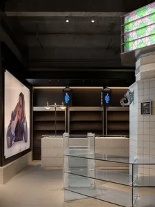 Modern retail store interior with concrete and glass elements.
