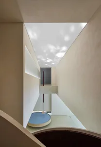 A minimalist interior design featuring circular concrete elements.