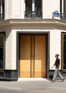 A minimalist retail storefront with wooden and glass elements.