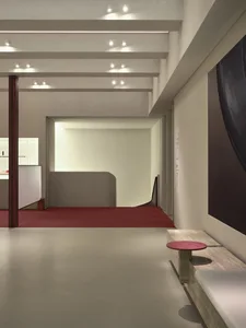 Modern interior design featuring concrete walls and floors in a lobby setting.