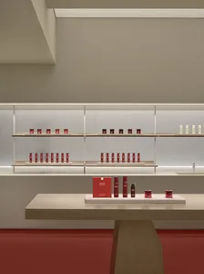 Modern retail storefront with white and red accents and minimalist design.