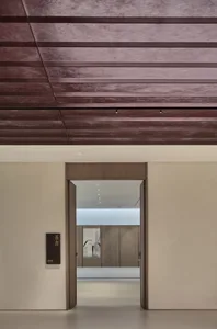 Modern minimalist lobby interior with concrete and wooden materials.