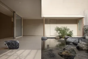 極簡室內空間結合混凝土與石材元素，搭配寧靜日式庭院，庭院內有岩石、水池與植物
