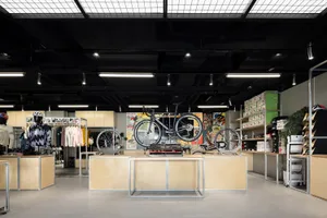 A cycling shop with wooden shelves, metal displays, and glass windows.