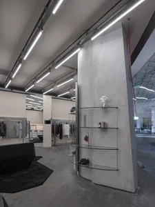 Industrial retail storefront with concrete walls and minimalist design.