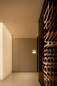 A minimalist corridor featuring glass walls and a sleek design.