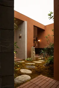 A modern landscape design featuring mossy ground cover and natural stone pathways.