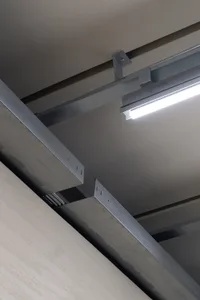 Modern industrial metallic beams connected with screws on a ceiling.