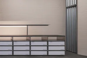 Minimalist furniture with metal drawers and shelves in a modern setting.
