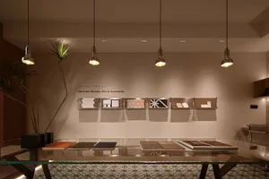 A modern office space featuring glass walls and wooden furnishings.
