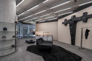 Modern retail storefront with concrete, glass, and metal materials