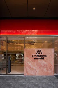 A retail storefront with a modern design featuring concrete and marble materials.