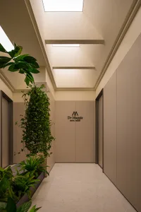 A minimalist office interior featuring modern design elements in white and green colors.
