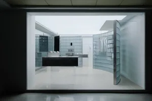 Minimalist retail store interior featuring glass and concrete materials