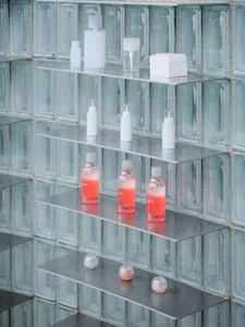 Shelves in a retail environment displaying beauty products in a sleek, modern setting.