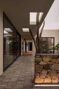 An indoor commercial space with brick walls, concrete flooring, and modern design elements.