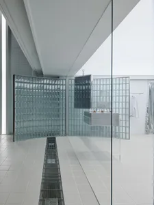 A modern bathroom with glass-block walls and a minimalist design.