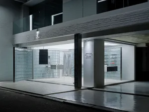 A modern storefront with a glass facade and white interior.