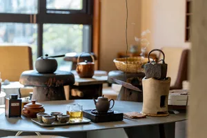 A detailed view of a ceramic tea room setup with various teapots and cups.