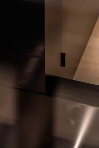 A minimalist interior space featuring metallic surfaces and sleek design.