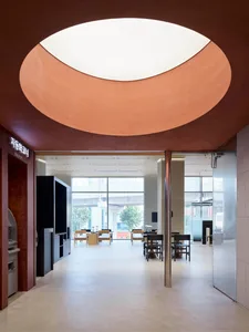 Modern interior design featuring concrete walls and a large circular window