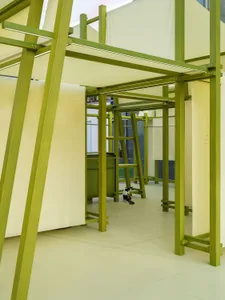 A modern installation composed of a green wooden structure with translucent panels