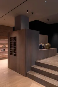 Modern retail store with wooden and concrete accents, featuring organized storage units.