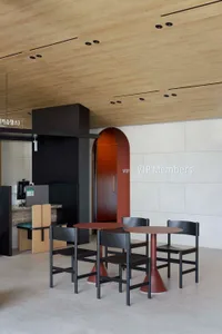 A modern VIP members lobby with metal furniture and a wooden ceiling.