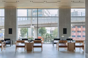 Modern work cafe featuring wooden tables and benches with concrete walls, image showcases sleek and minimalist design