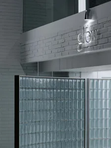 Industrial marketing office interior with glass block walls, brick accents, and concrete finishes.