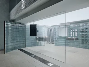 A modern retail display with walls made of translucent glass blocks, creating a minimalist and open space.