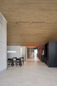 Interior design of a modern office space featuring concrete flooring and walls.