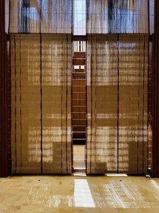 Bamboo window treatment with natural light filtering through the slats, creating a serene and minimalist interior space.